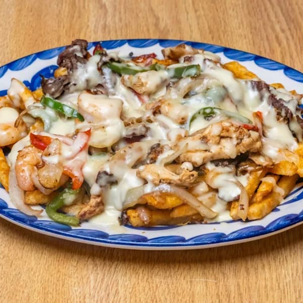 La Calera Mexican Bar & Grill's fries topped with melted cheese, steak, chicken, shrimp, and vegetables.