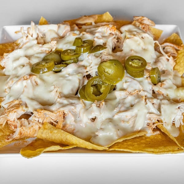 La Calera Mexican Bar & Grill's chicken nachos, generously topped with melted white cheese and sliced jalapeños.