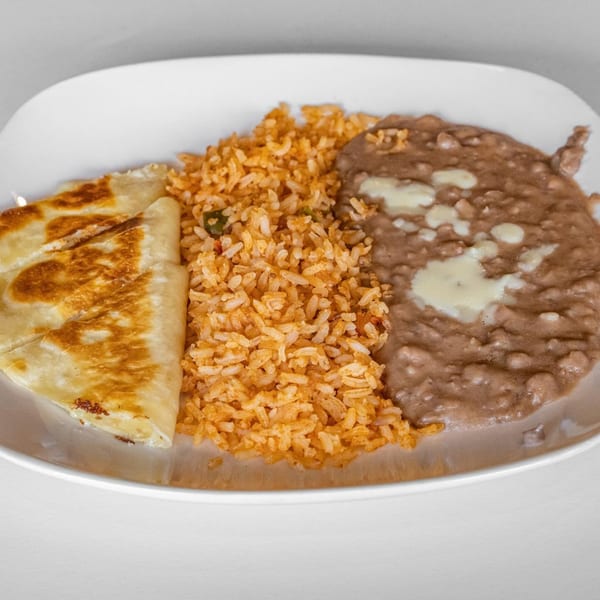 A La Calera Mexican Bar & Grill plate with a quesadilla, rice, and refried beans.